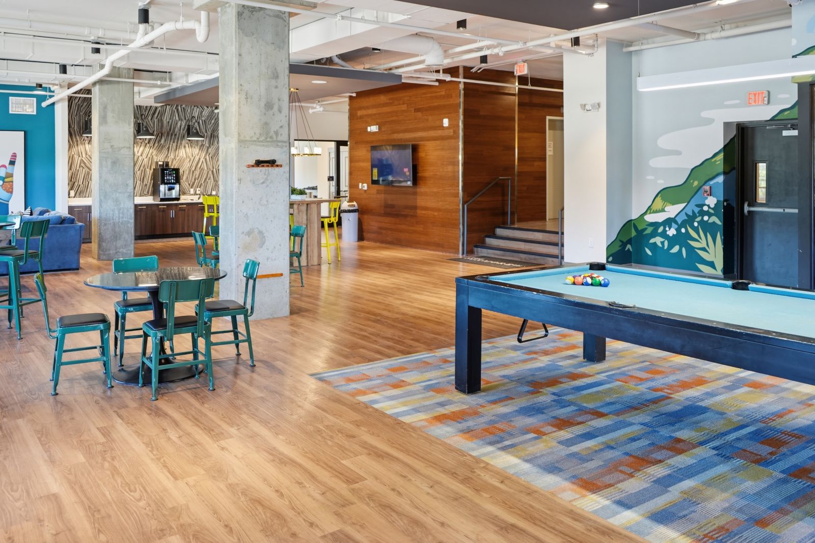 Resident clubhouse with billiards, café seating, lounge areas, and modern finishes for socializing and studying.